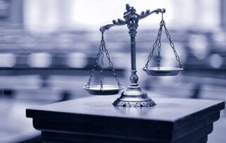 Absolute Liability, Strict Liability Full Mens Rea Ontario portrayed by the scales of justice displayed in a Canadian court.